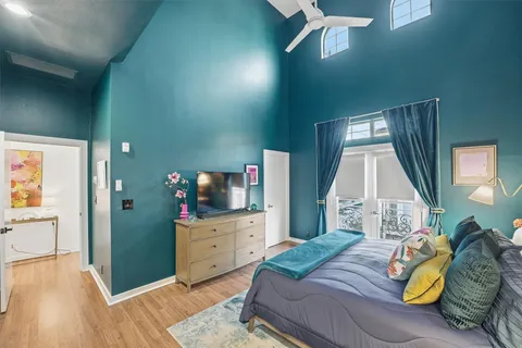 a bedroom with a bed and a wooden floor