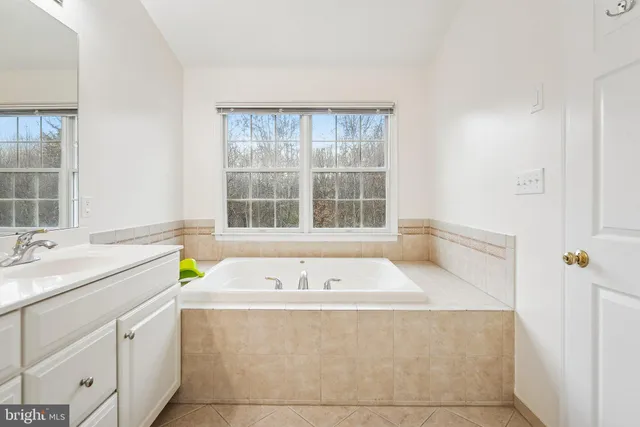 a bath tub sitting next to a window