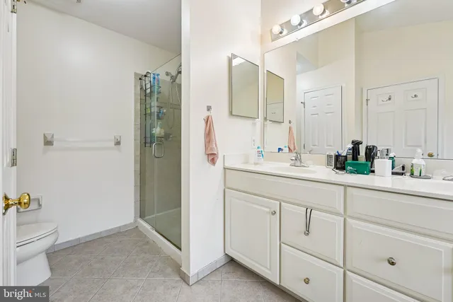 a bathroom with a shower sink and toilet