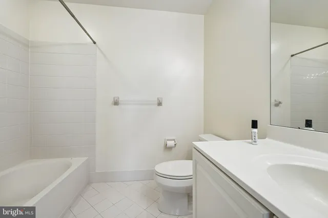 a bathroom with a sink a toilet and bathtub