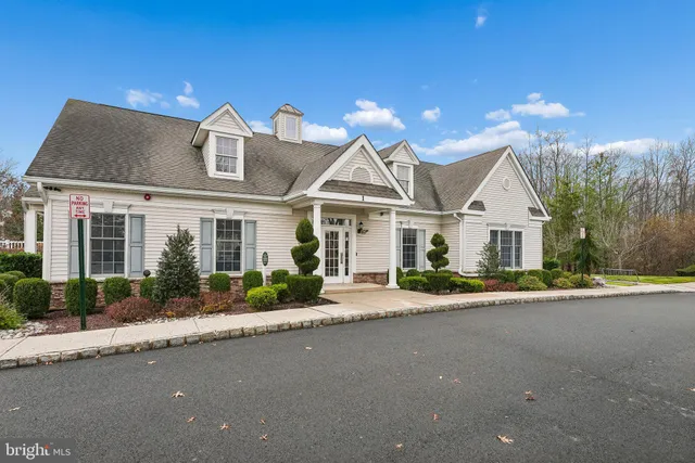 a front view of a house with a yard and potted plants