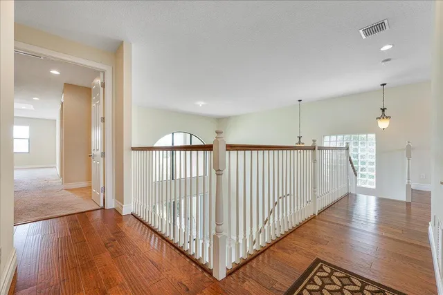 a view of a hallway with wooden floor