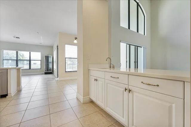 a bathroom with a sink a mirror and next to a window
