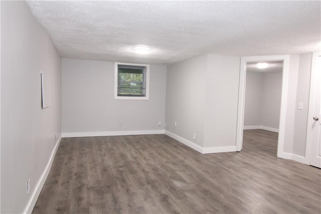 2187 Plantation Lane, Unit B Chamblee, GA 30341 - Photo 12 of 25 an empty room with wooden floor and windows