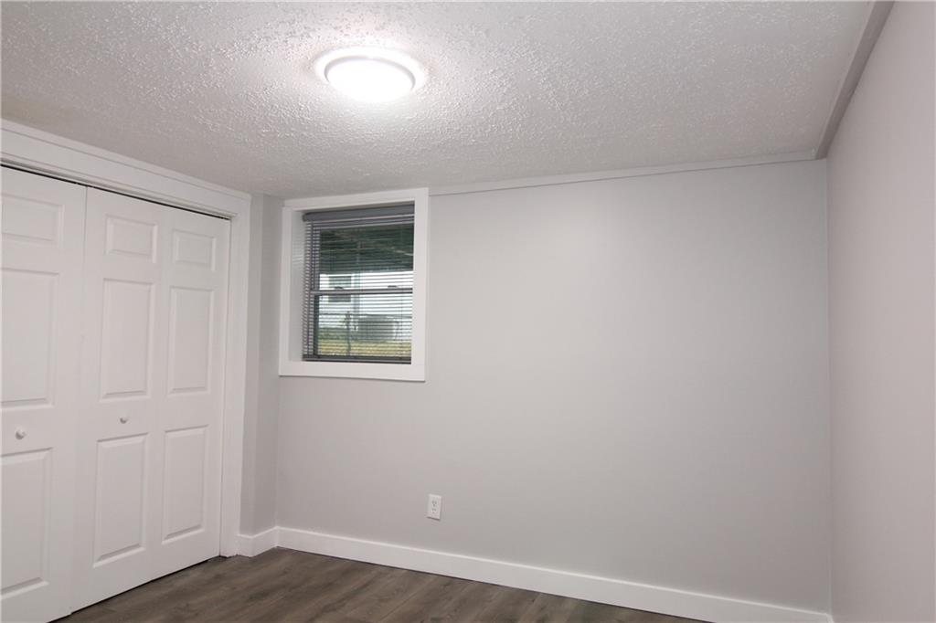 2187 Plantation Lane, Unit B Chamblee, GA 30341 - Photo 15 of 25 an empty room with wooden floor and windows