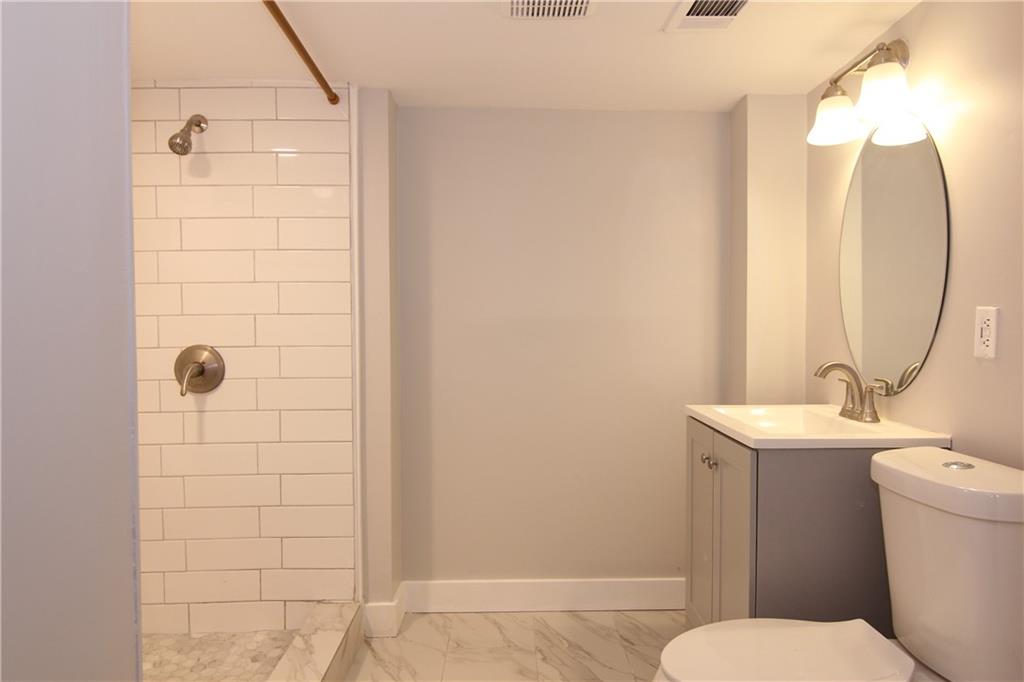 2187 Plantation Lane, Unit B Chamblee, GA 30341 - Photo 16 of 25 a bathroom with a sink a toilet and shower