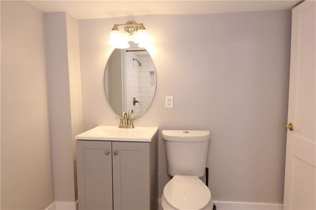 2187 Plantation Lane, Unit B Chamblee, GA 30341 - Photo 17 of 25 a bathroom with a toilet a sink and mirror