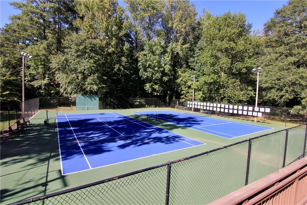 2187 Plantation Lane, Unit B Chamblee, GA 30341 - Photo 22 of 25 a view of a tennis ground with large trees