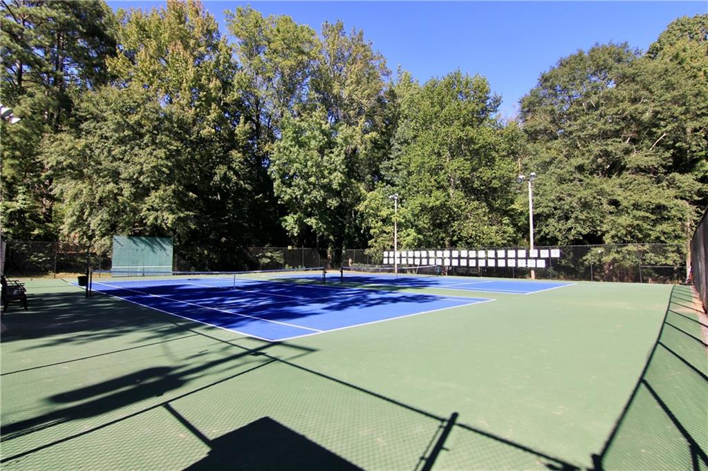 2187 Plantation Lane, Unit B Chamblee, GA 30341 - Photo 23 of 25 a view of a tennis ground with large trees
