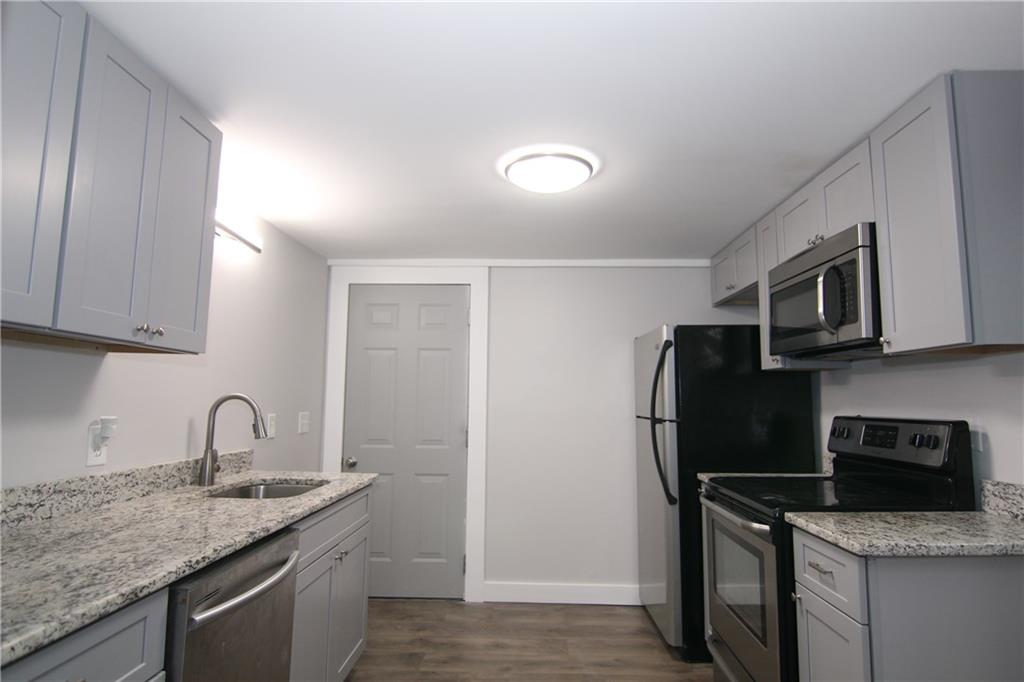 2187 Plantation Lane, Unit B Chamblee, GA 30341 - Photo 3 of 25 a kitchen with stainless steel appliances granite countertop a refrigerator sink and stove