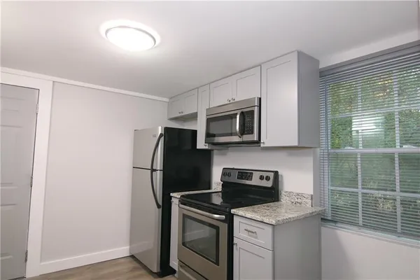 a kitchen with a stove and a microwave