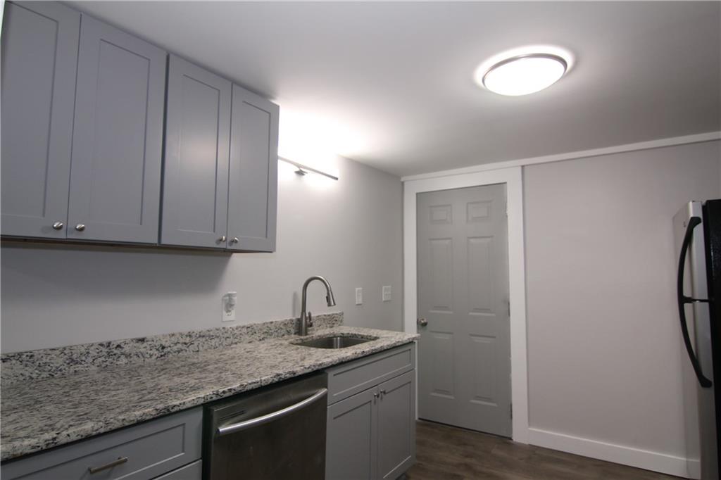 2187 Plantation Lane, Unit B Chamblee, GA 30341 - Photo 7 of 25 a kitchen with a sink cabinets and a refrigerator