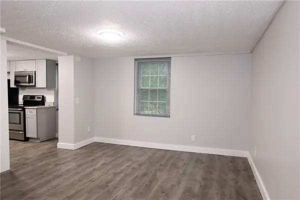 a view of a kitchen with an empty space and a window