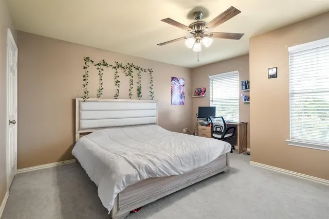 a bathroom with a sink a toilet a mirror and shower curtain
