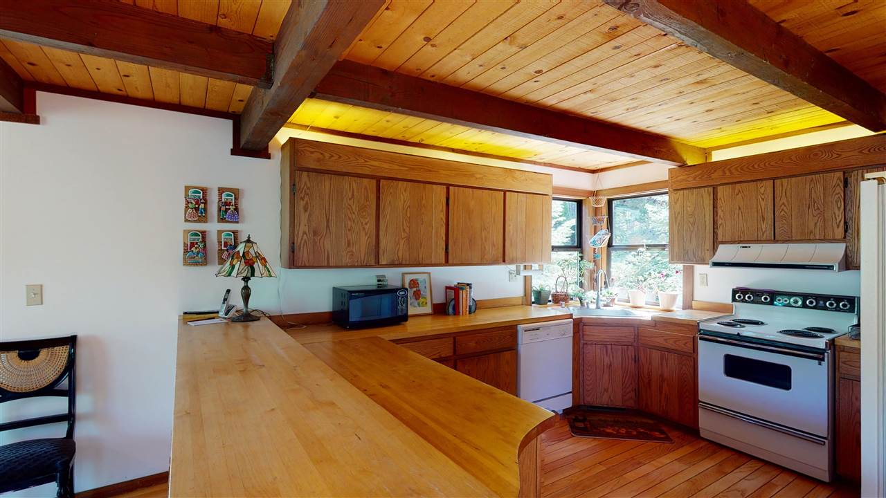 1069 Snow Crest Road Alpine Meadows, CA 96146 - Photo 4 of 20 a kitchen with a sink a stove cabinets and a dining table
