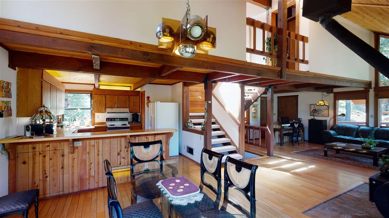 1069 Snow Crest Road Alpine Meadows, CA 96146 - Photo 5 of 20 a view of a dining room with furniture wooden floor and a chandelier