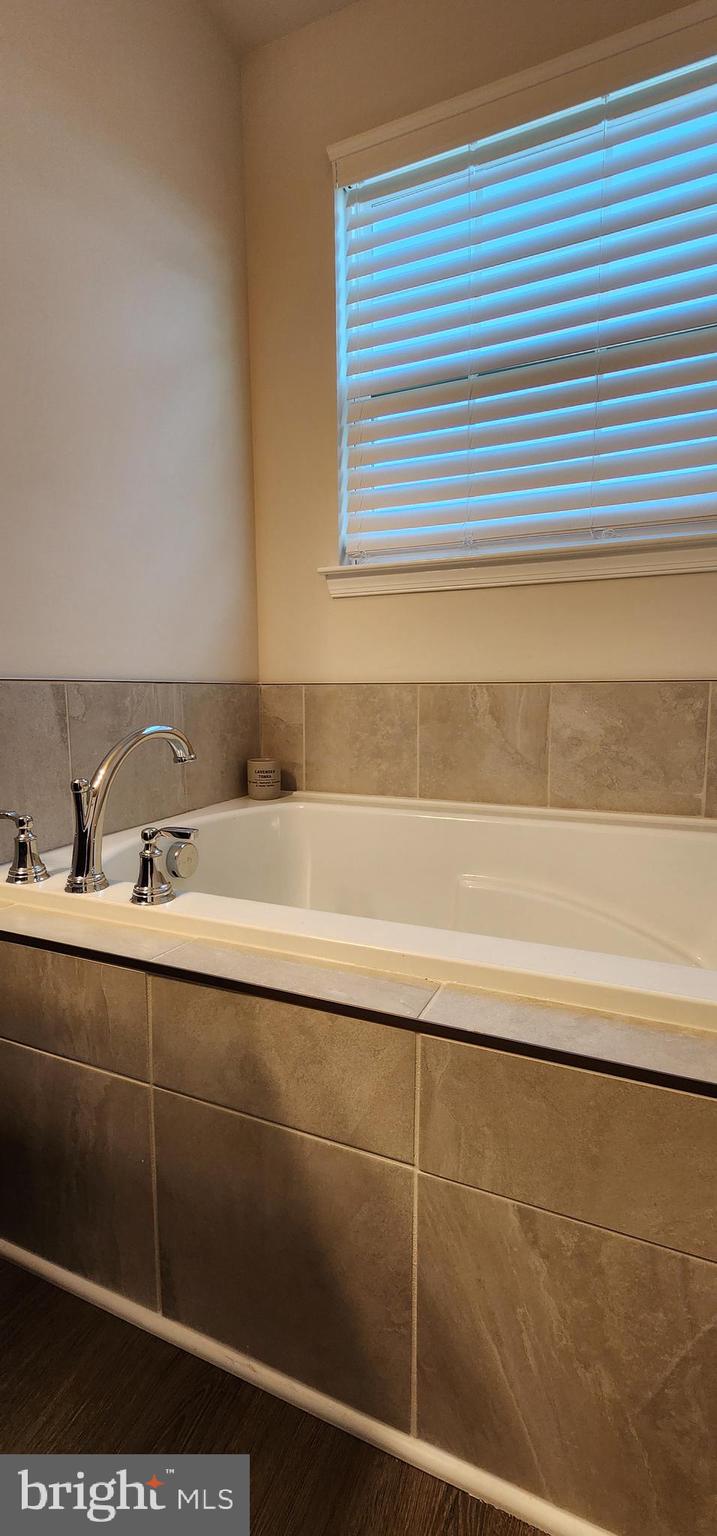 104 Commerce Sicklerville, NJ 08081 - Photo 12 of 16 a bathroom with a sink and a bathtub