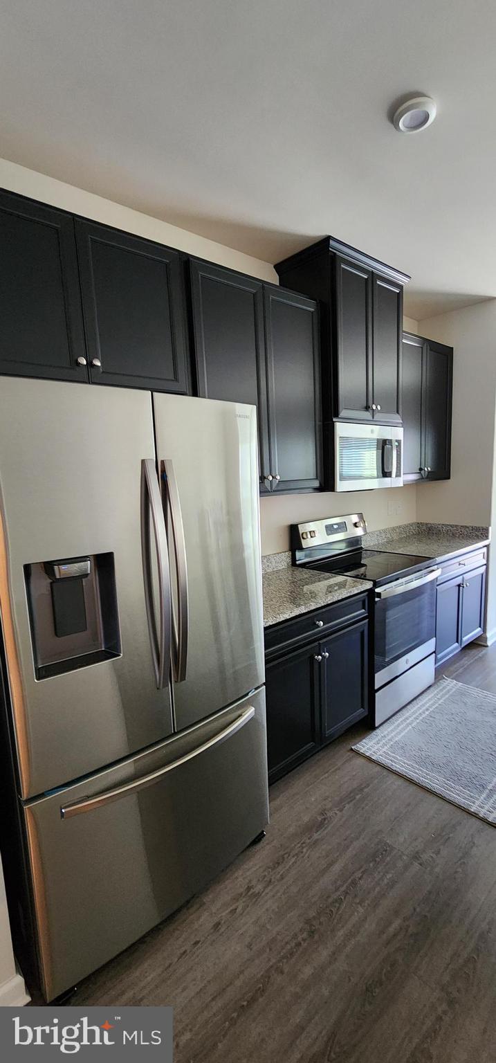 104 Commerce Sicklerville, NJ 08081 - Photo 3 of 16 a kitchen with stainless steel appliances and wooden cabinets