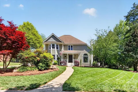 a front view of a house with a garden and porch