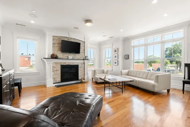 a living room with furniture flat screen tv and a fireplace
