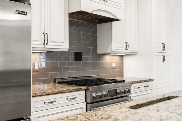 a stove top oven sitting inside of a kitchen