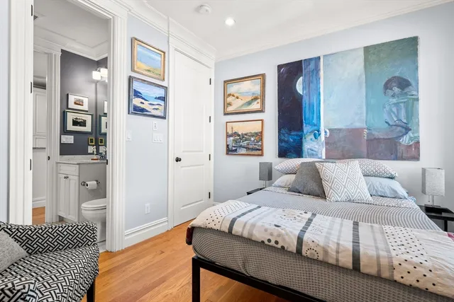 a bedroom with a large bed and a window