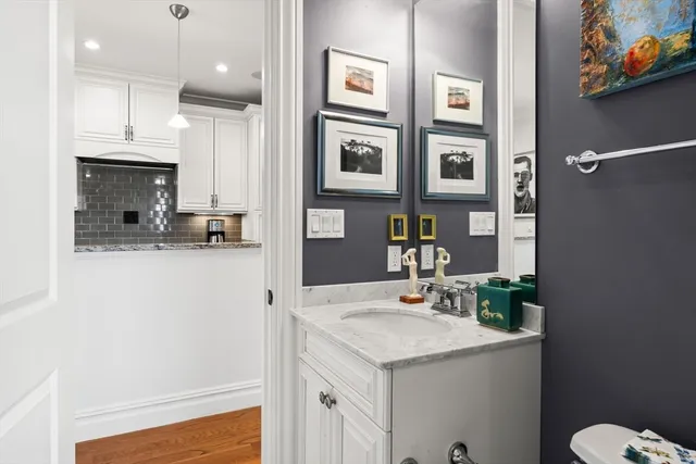 a bathroom with a sink a toilet and a mirror