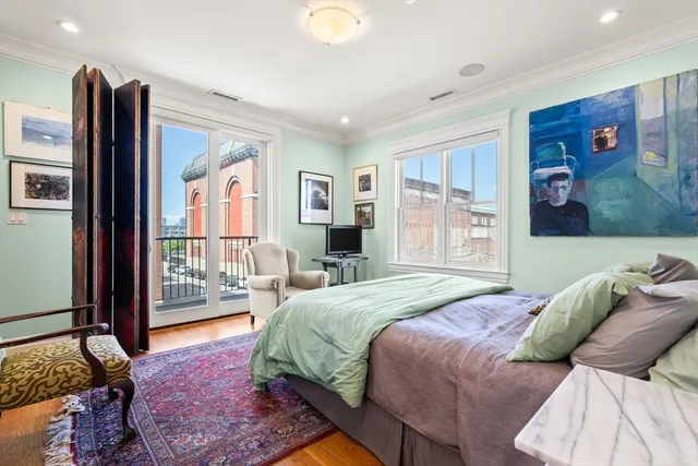 a bedroom with a large bed and a window