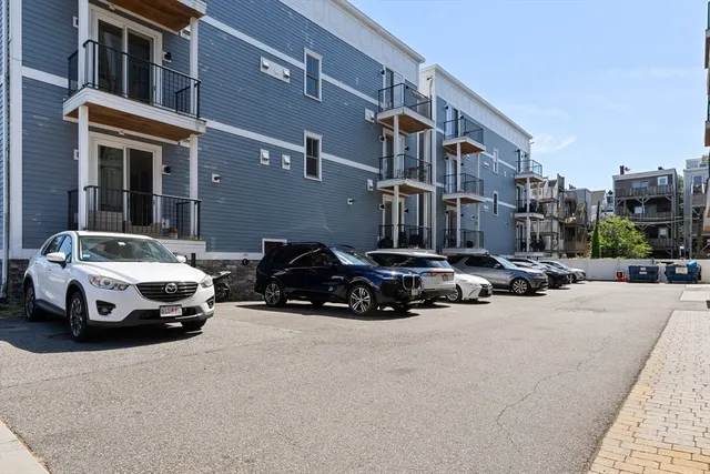 a car parked in front of a white house