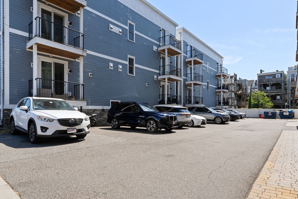 3 M Street, Unit 3 Boston, MA 02127 - Photo 26 of 34 a car parked in front of a white house