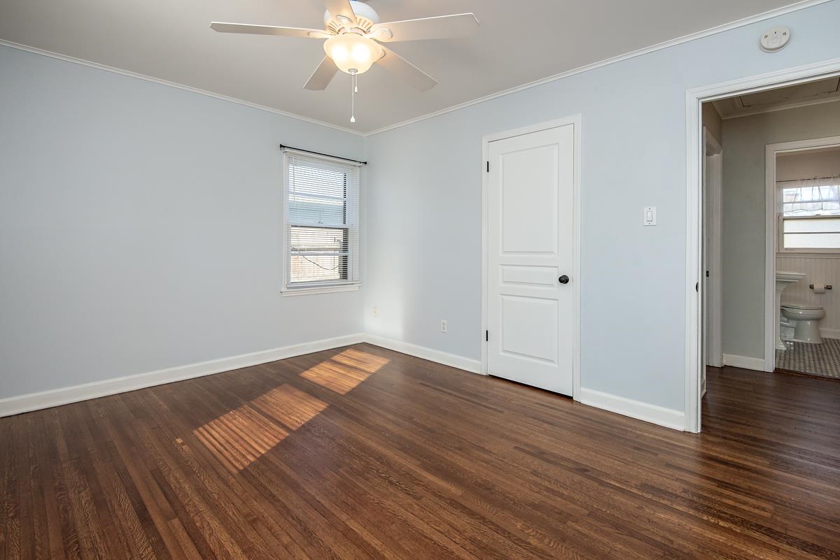 4628 Boyce Road Memphis, TN 38117 - Photo 14 of 25 an empty room with wooden floor and windows