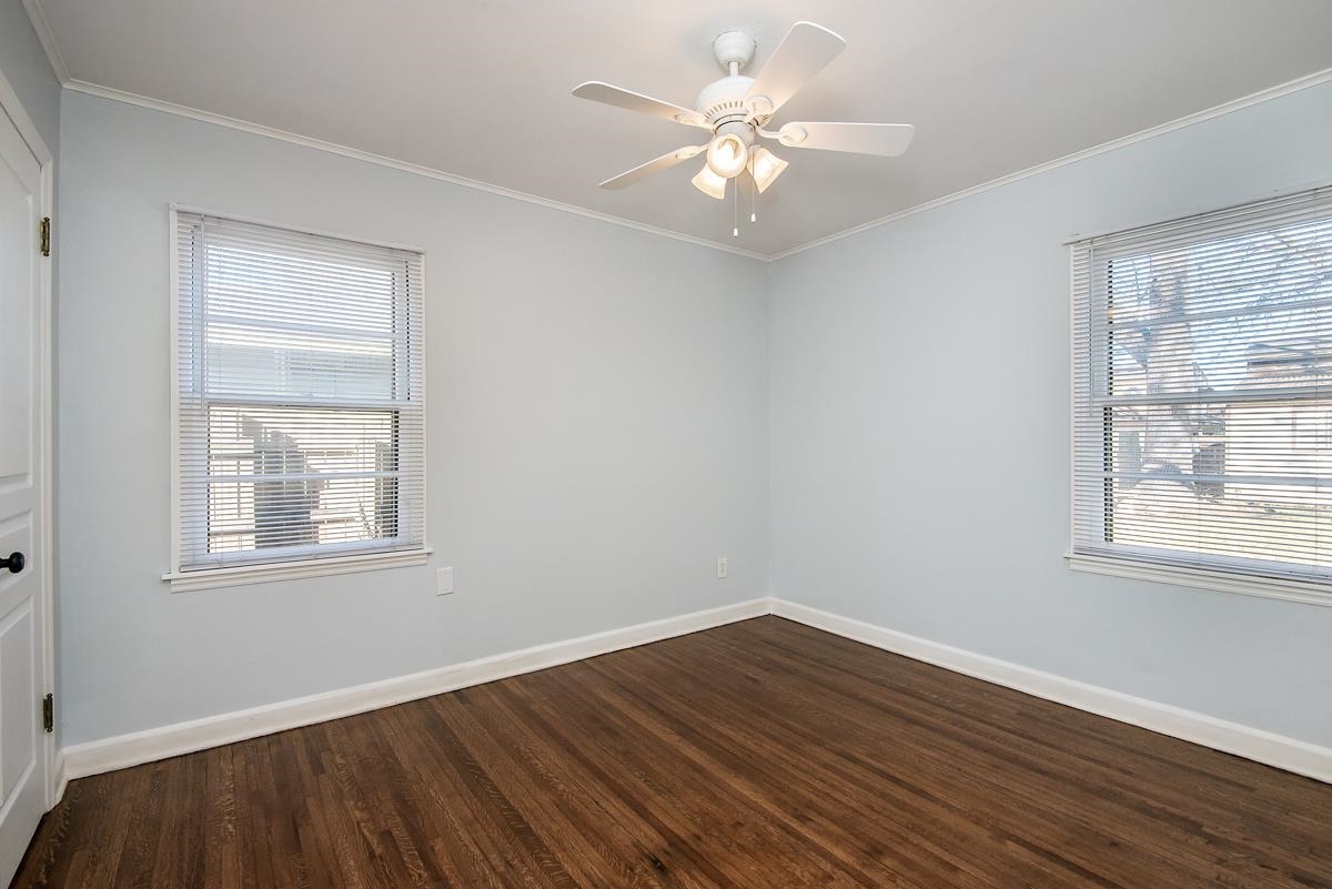 4628 Boyce Road Memphis, TN 38117 - Photo 15 of 25 an empty room with wooden floor and windows