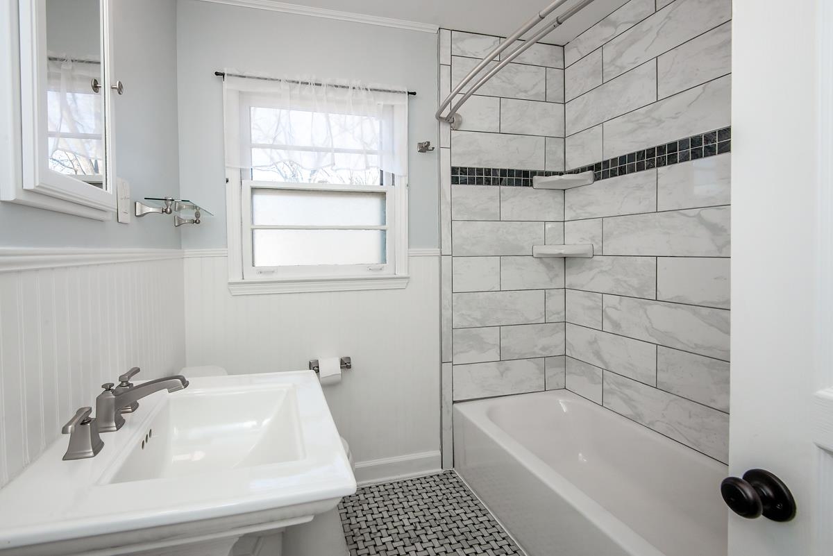 4628 Boyce Road Memphis, TN 38117 - Photo 16 of 25 a bathroom with a bathtub a window and a shower