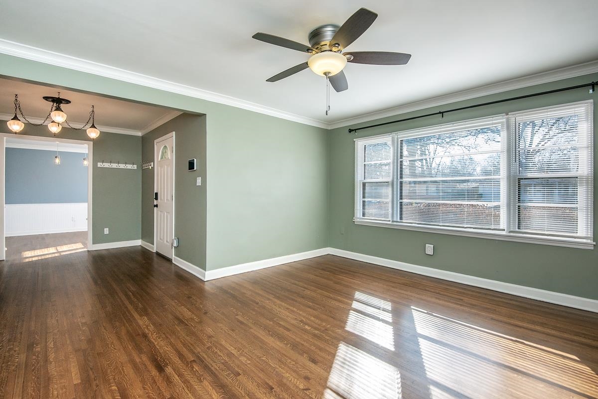 4628 Boyce Road Memphis, TN 38117 - Photo 3 of 25 a view of an empty room with wooden floor and a window