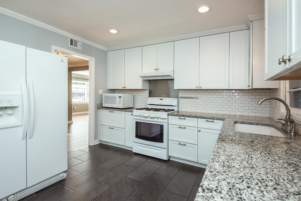 4628 Boyce Road Memphis, TN 38117 - Photo 6 of 25 a kitchen with stainless steel appliances granite countertop a refrigerator sink and cabinets