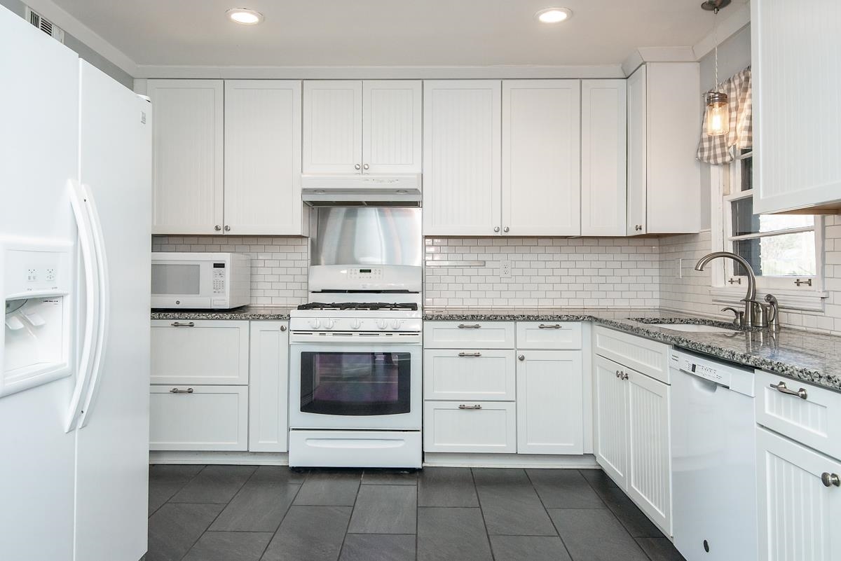 4628 Boyce Road Memphis, TN 38117 - Photo 8 of 25 a kitchen with white cabinets stainless steel appliances and sink