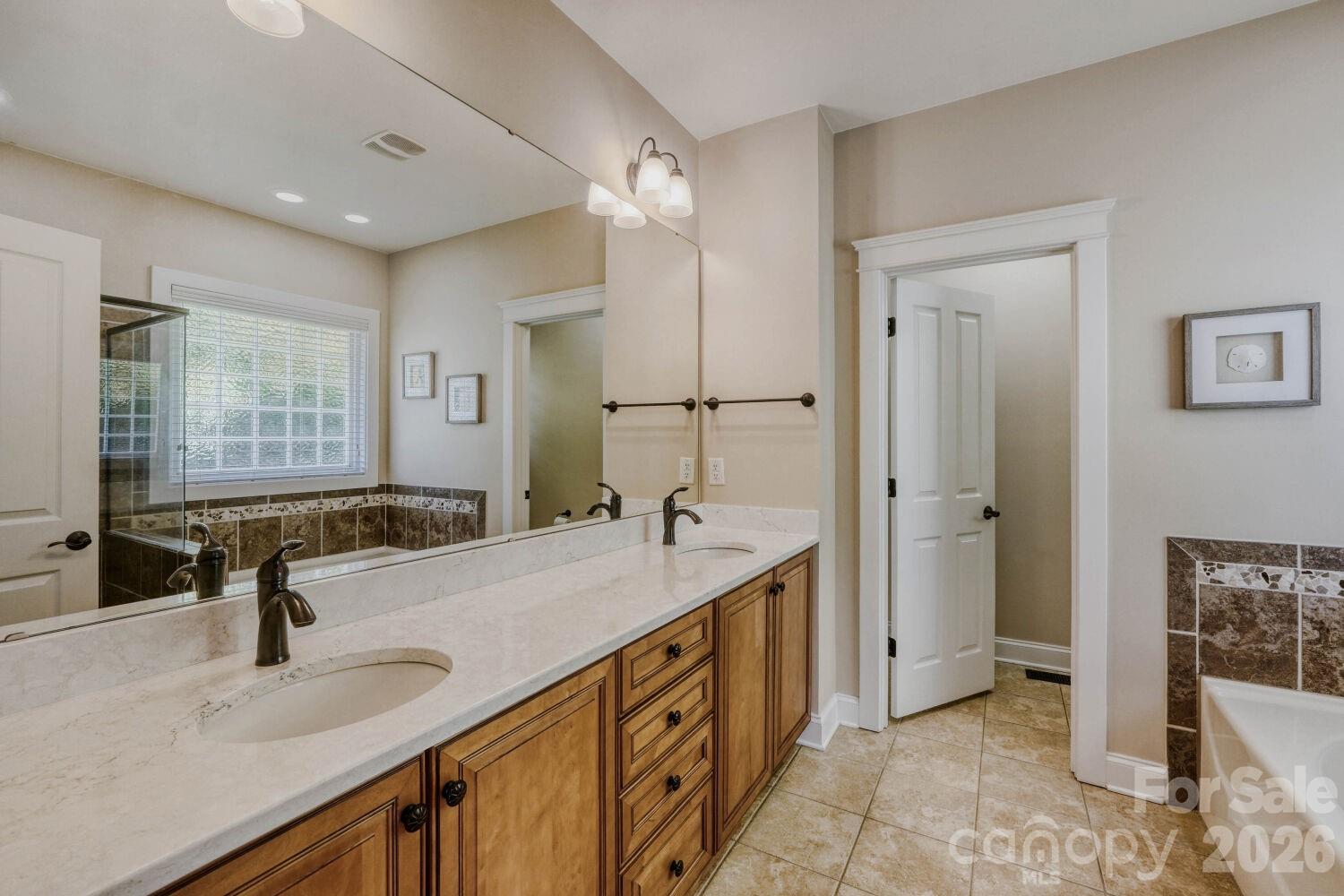 183 Lavender Bloom Loop Mooresville, NC 28115 - Photo 17 of 46 a bathroom with a sink double vanity and shower