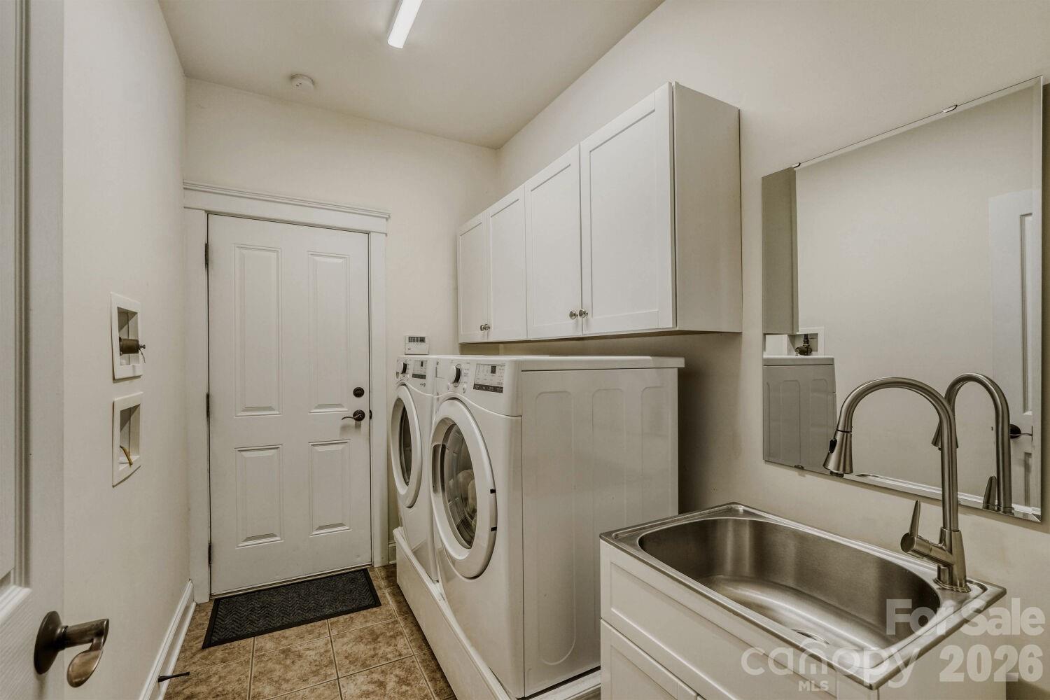 183 Lavender Bloom Loop Mooresville, NC 28115 - Photo 19 of 46 a close view of a sink and a washer in a room