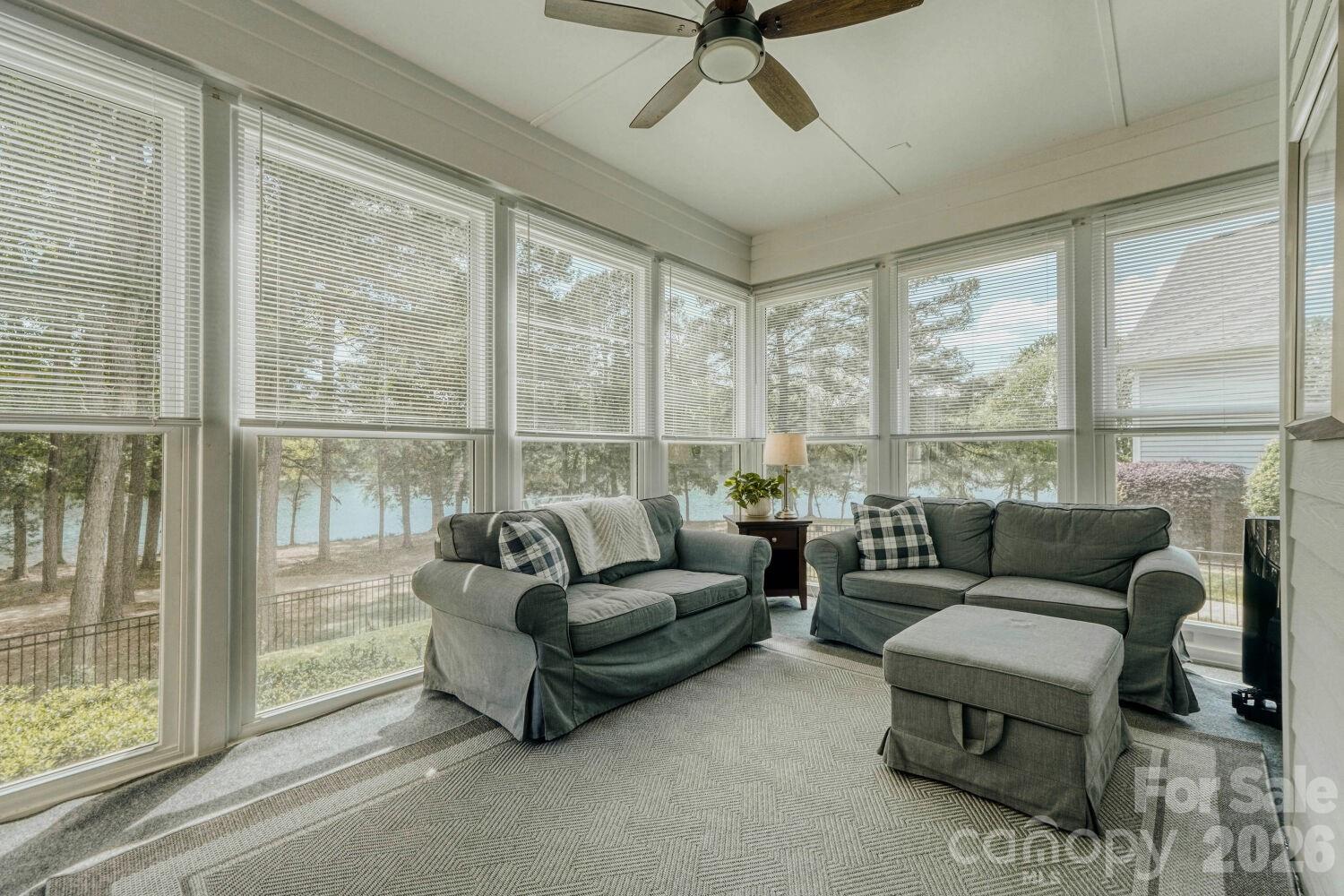 183 Lavender Bloom Loop Mooresville, NC 28115 - Photo 20 of 46 a living room with furniture and a floor to ceiling window