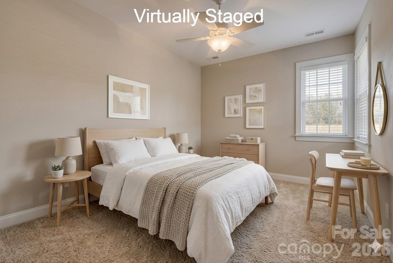 183 Lavender Bloom Loop Mooresville, NC 28115 - Photo 24 of 46 a bedroom with a bed a table and windows