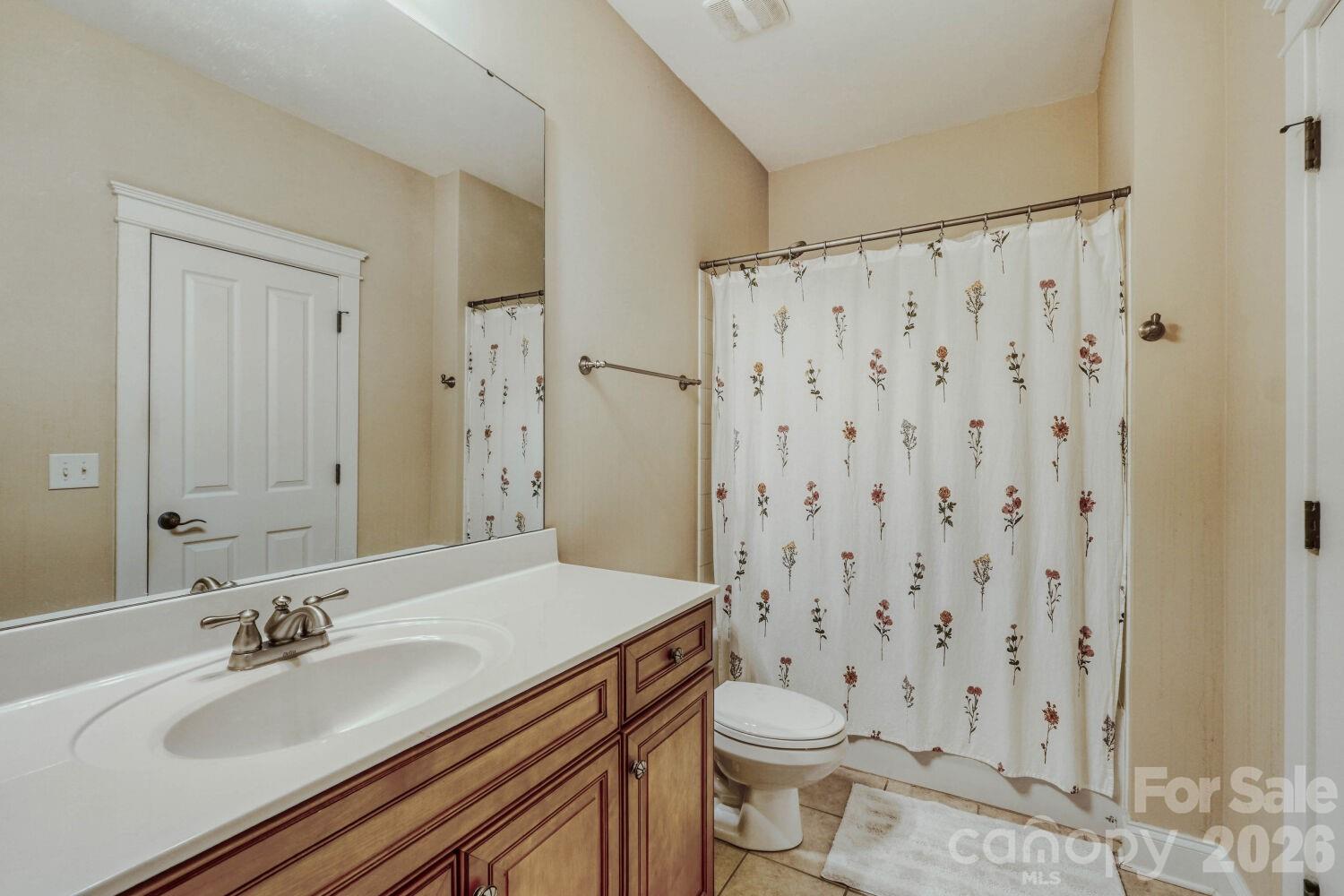 183 Lavender Bloom Loop Mooresville, NC 28115 - Photo 31 of 46 a bathroom with a granite countertop sink toilet a mirror and shower curtain