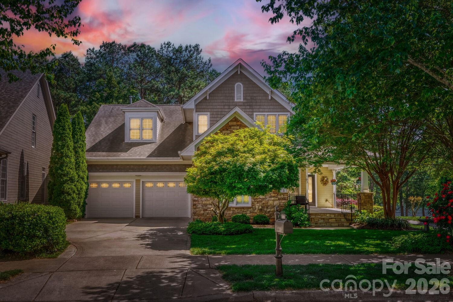183 Lavender Bloom Loop Mooresville, NC 28115 - Photo 45 of 46 a front view of a house with a garden and trees