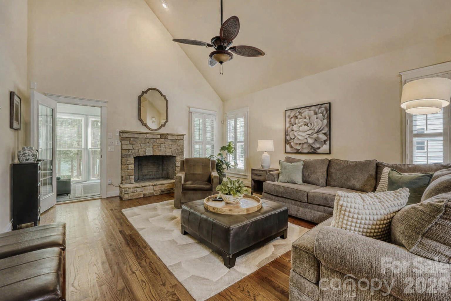 183 Lavender Bloom Loop Mooresville, NC 28115 - Photo 6 of 46 a living room with furniture a fireplace and a flat screen tv