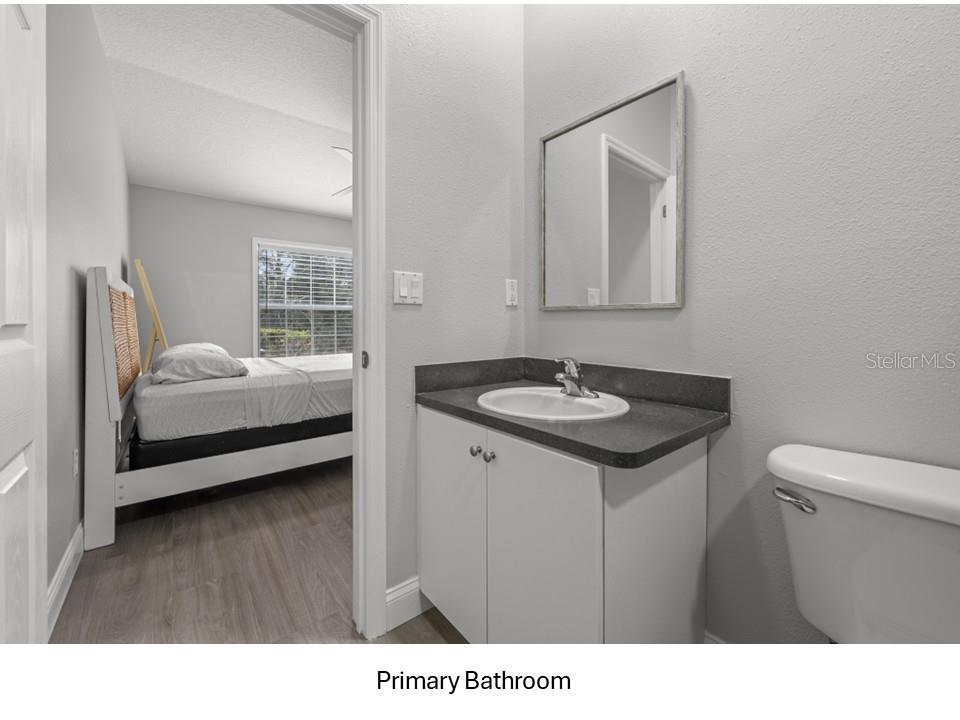 8516 Corinthian Way New Port Richey, FL 34654 - Photo 11 of 24 a en suite bathroom with a sink and a mirror