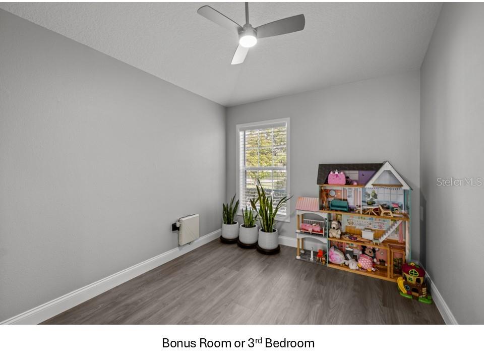 8516 Corinthian Way New Port Richey, FL 34654 - Photo 14 of 24 a room with furniture and a wooden floor