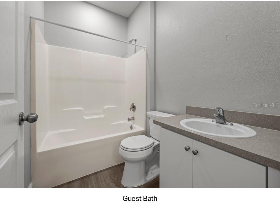 8516 Corinthian Way New Port Richey, FL 34654 - Photo 16 of 24 a bathroom with a sink a toilet and a bathtub