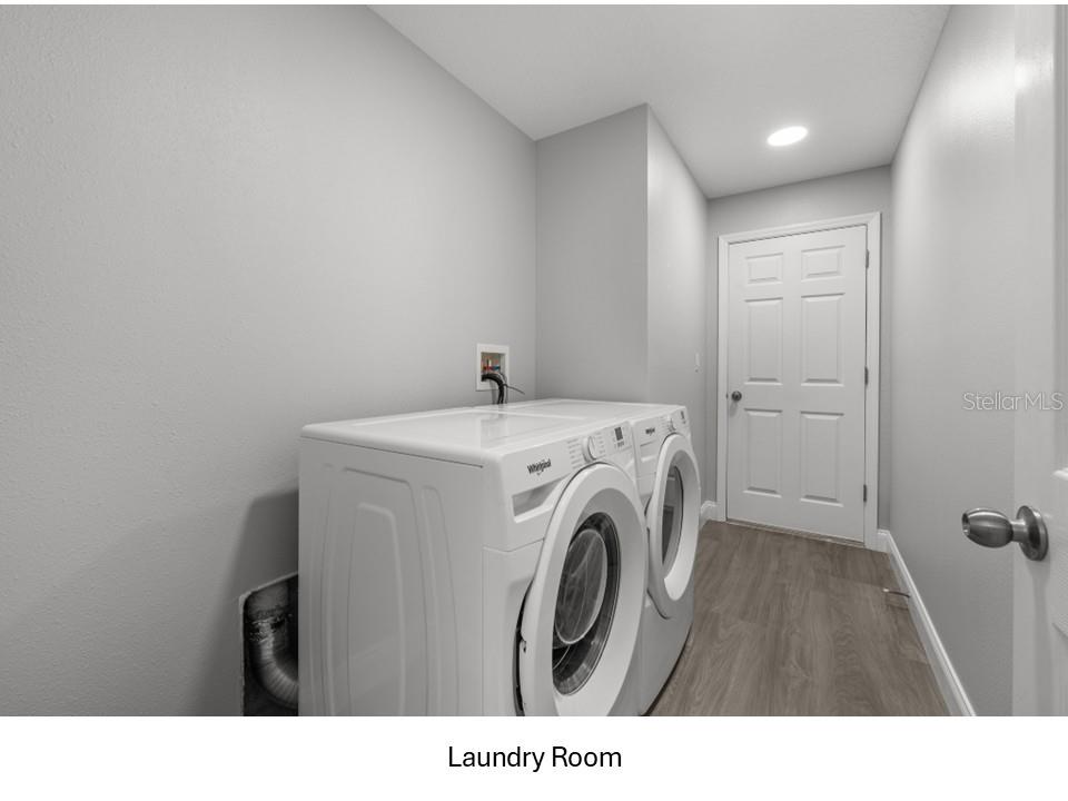 8516 Corinthian Way New Port Richey, FL 34654 - Photo 17 of 24 a utility room with dryer and washer
