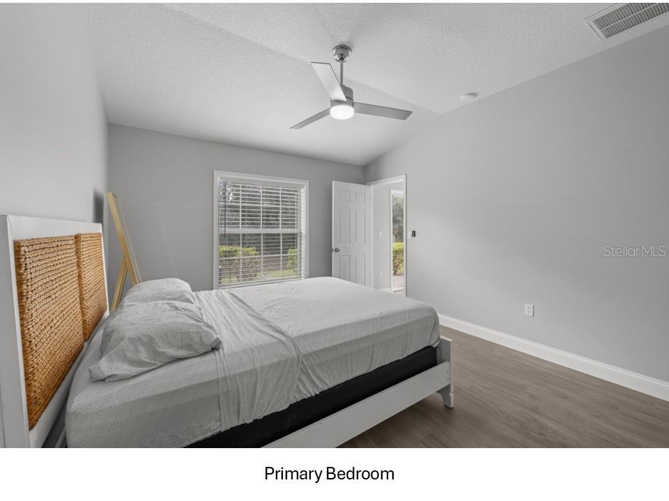 8516 Corinthian Way New Port Richey, FL 34654 - Photo 9 of 24 a living room with a bed furniture and a window