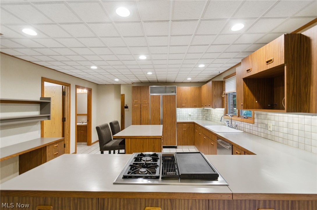 200 Hampshire Road Akron, OH 44313 - Photo 16 of 50 Expansive kitchen featuring a built-in cooktop with griddle, extensive wood-finish cabinetry, a large refrigerator, and recessed lighting
