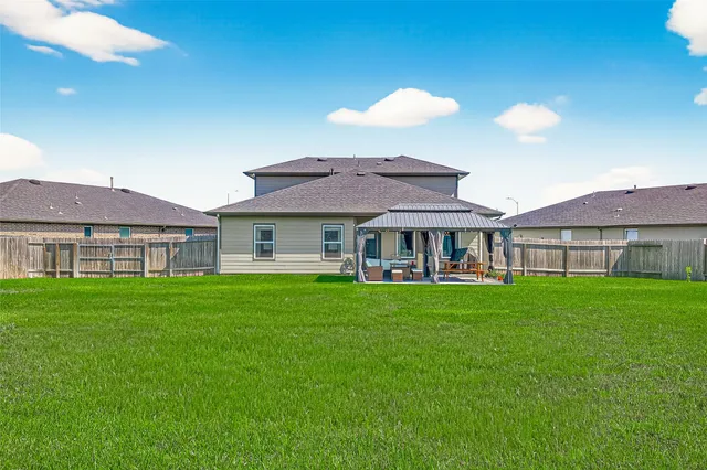 a view of a house with backyard porch and sitting area